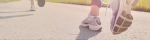 Close Up of Runner's Shoes on Paved Trail | RNVPodiatry Close Up of Runner's Shoes on Paved Trail