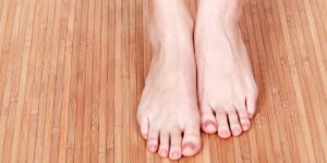Two feet on wood surface for problems caused by diabetes
